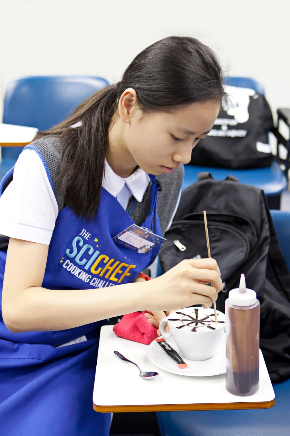 A challenger is working on her latte art