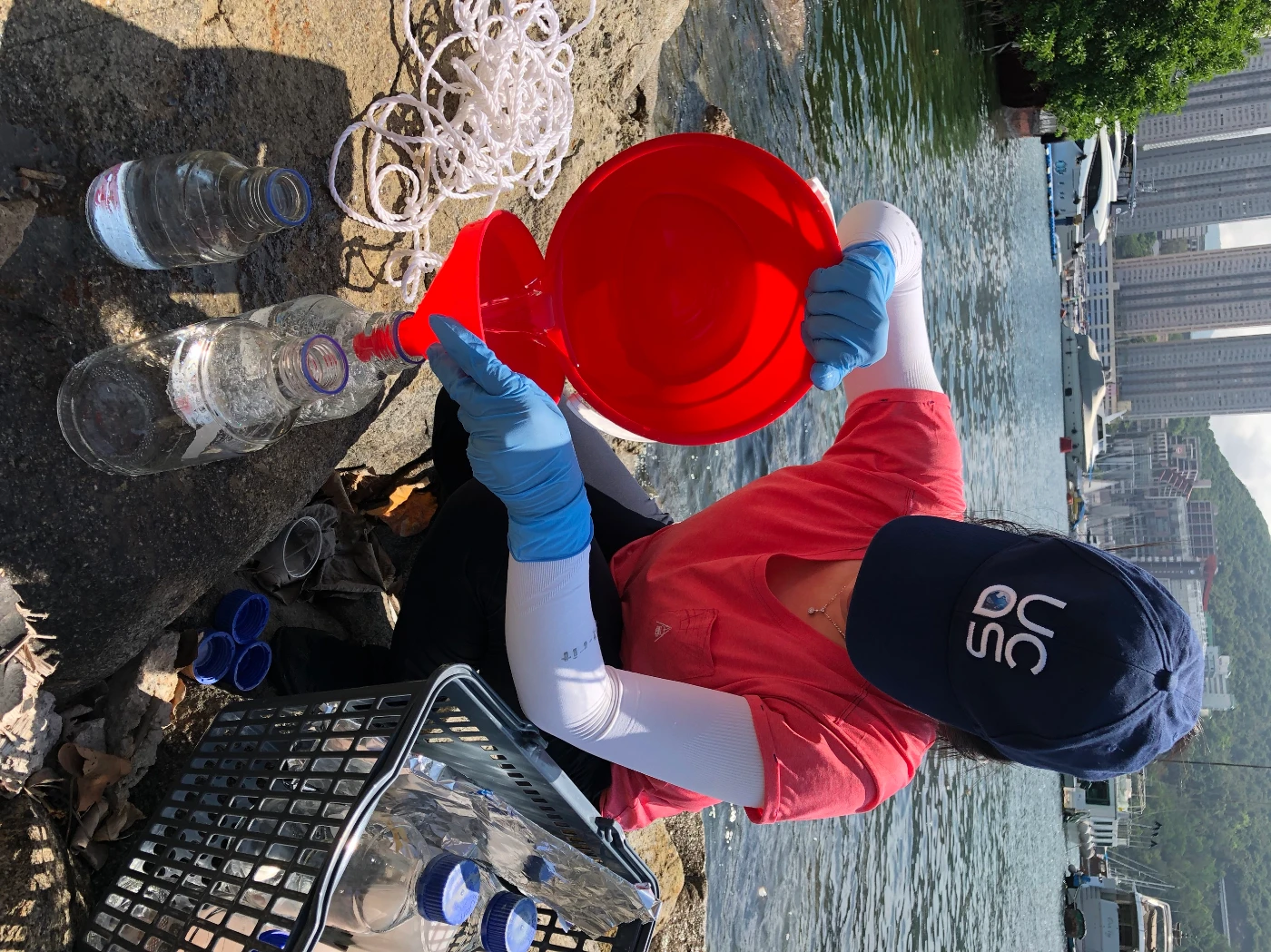 Katie Yeung collects a seawater sample from Aberdeen