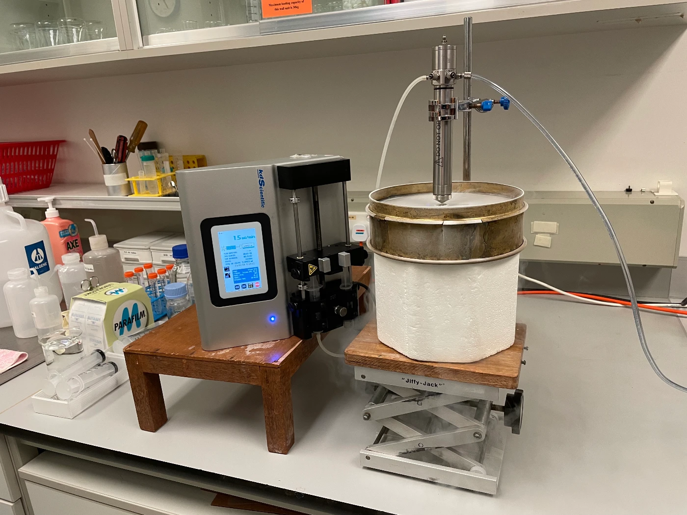 Photos of ‘spray-freezing’ step in spray freeze drying process. Liquid is fed into a nozzle and atomised into fine droplets. Those droplets fall into liquid nitrogen (inside the white styrofoam container) and become frozen.