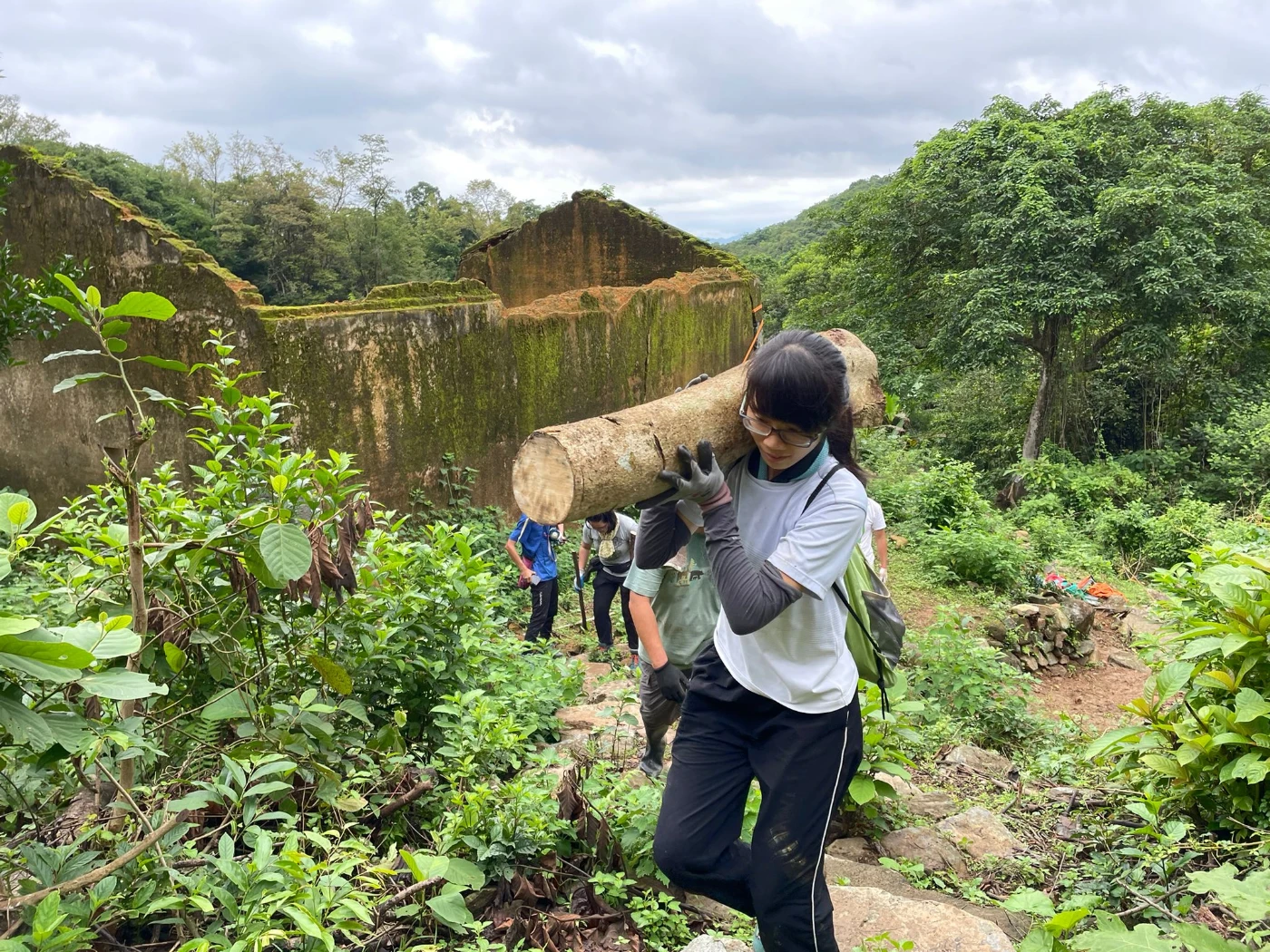 Volunteers participate in repairing handcrafted trail