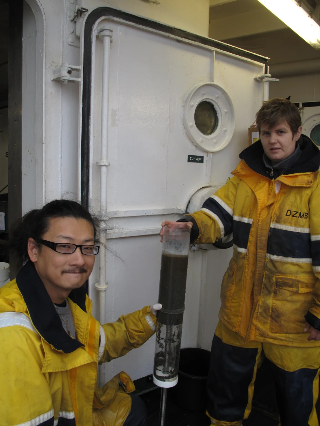 Image 2: Dr Moriaki Yasuhara (left) and a research colleague studying a core of
       sediment sampled from the deep sea.
